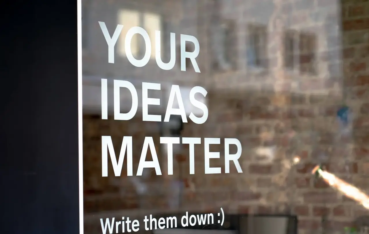 Innovation_Unsplash_mika-baumeister-LaqL8nxiacc Schriftzug "your ideas matter" auf Schaufensterscheibe